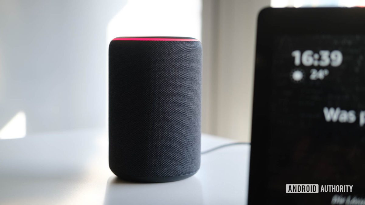 An Amazon Echo (second-gen) on a white surface.