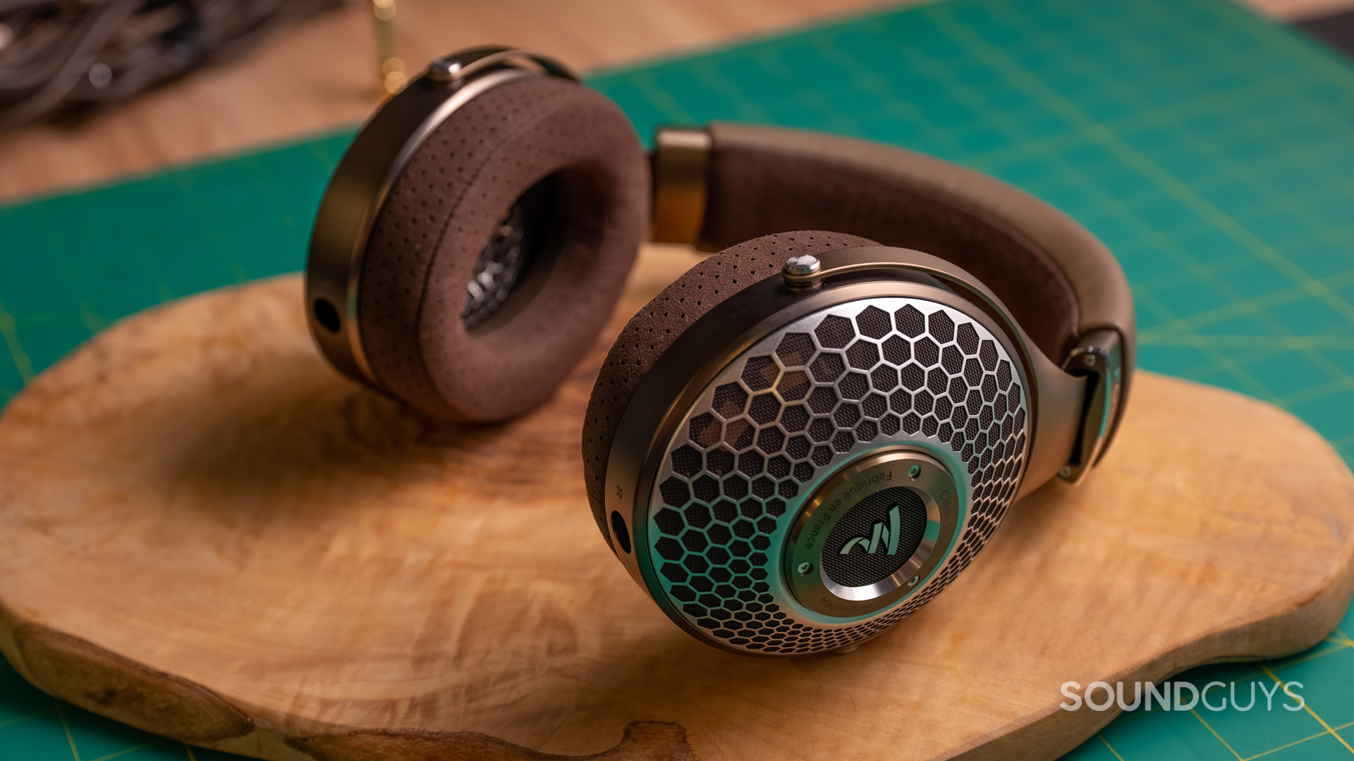 A photo of the Focal Clear MG headphones lying atop wood.