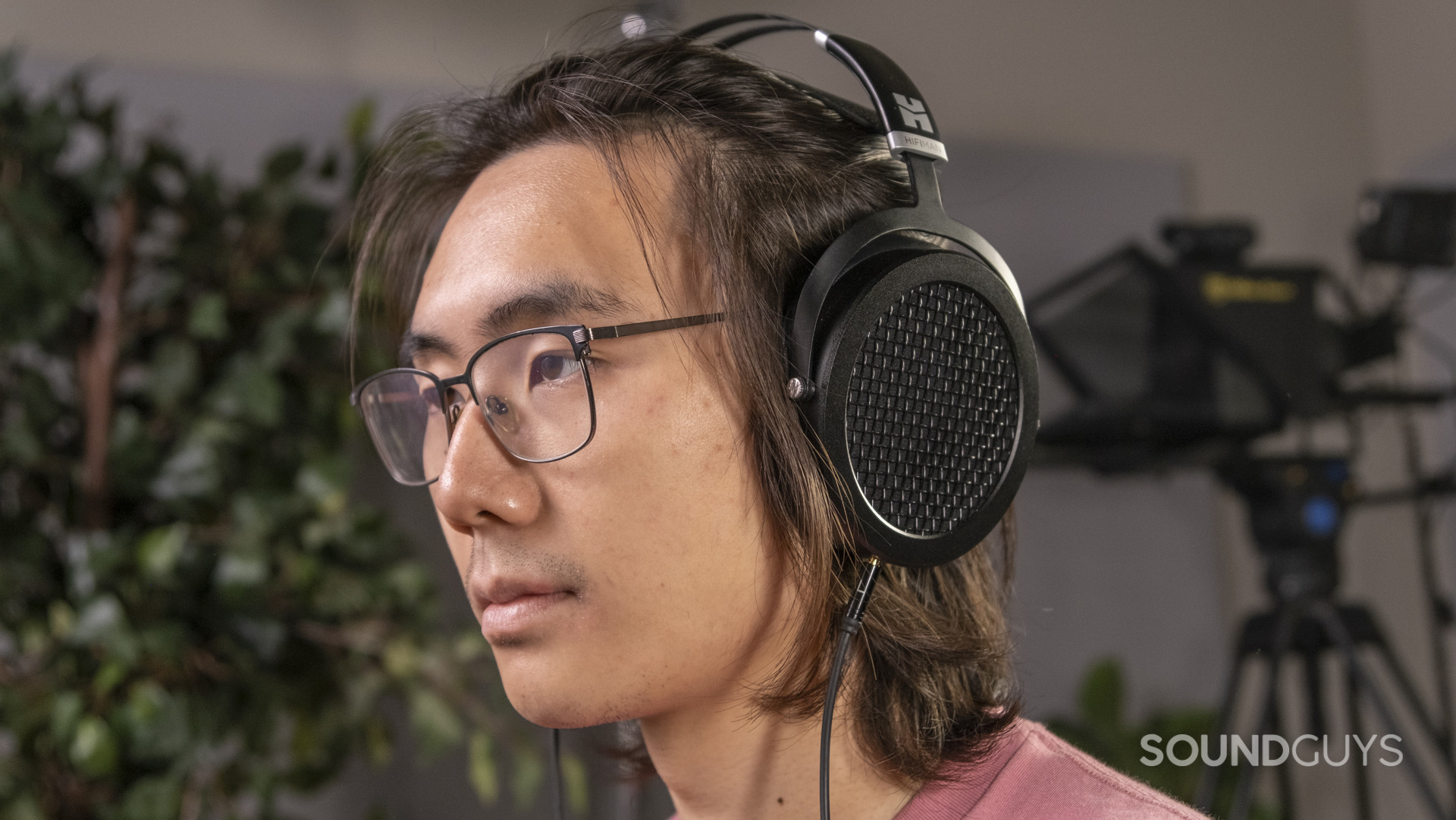A person wears the HiFiMan Sundara headphones in an office setting.