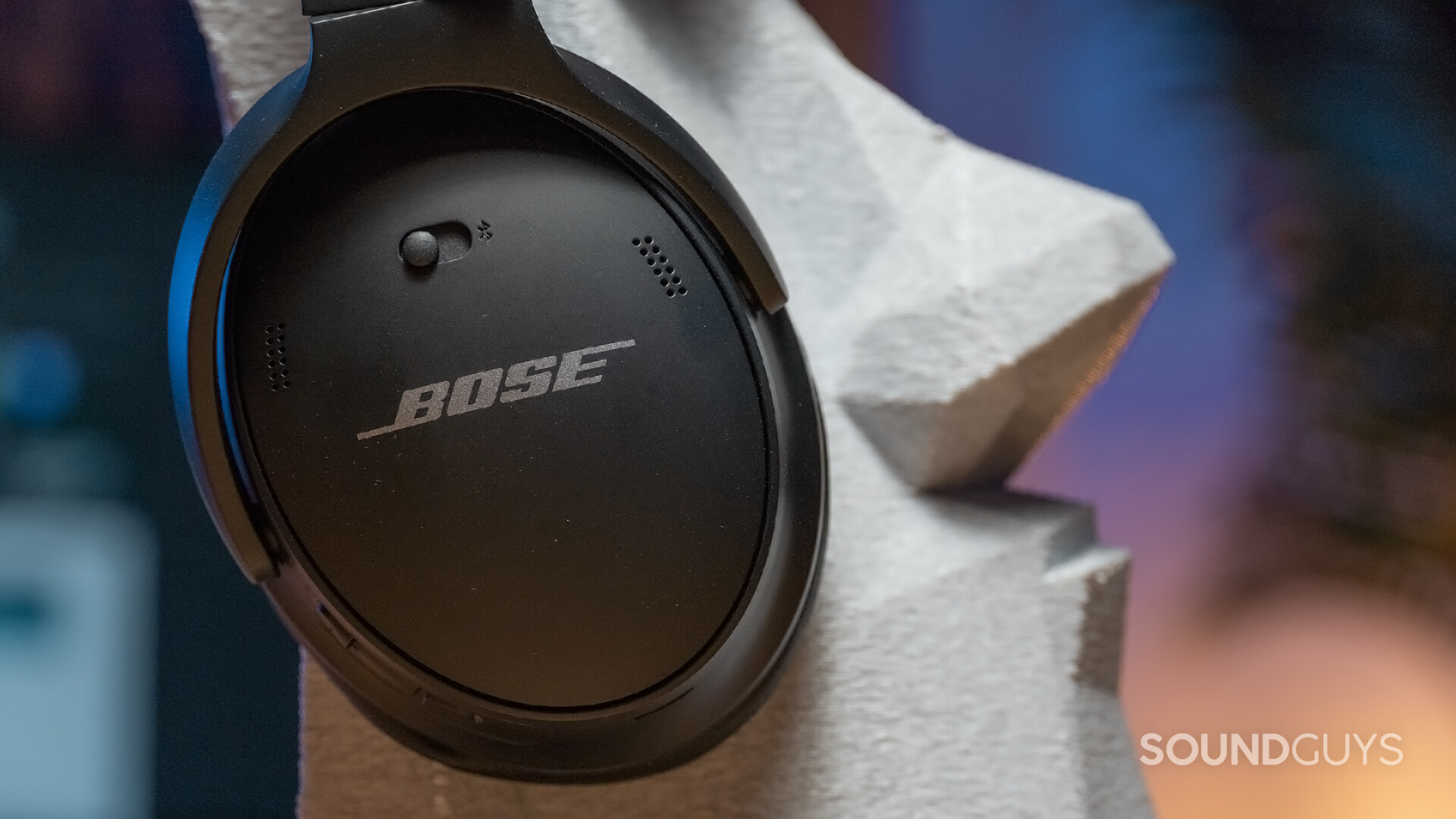 The Bose QuietComfort 45 headphones on a statue head.