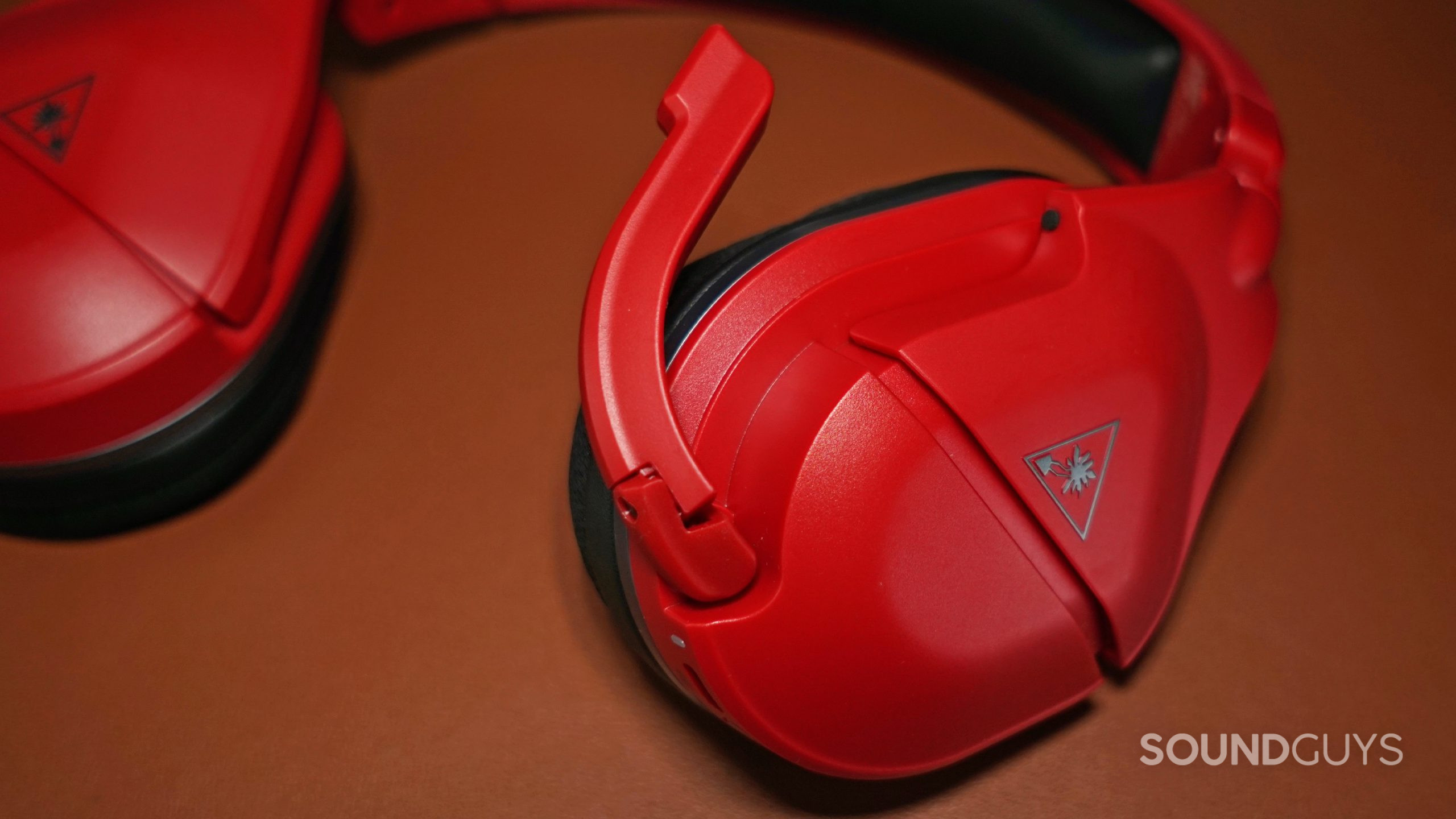 The Turtle Beach Stealth 600 Gen 2 MAX lays on a leather surface with its microphone flipped out.